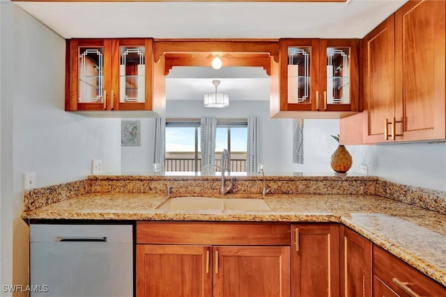 kitchen featuring glass insert cabinets, brown cabinets, dishwasher, and a sink