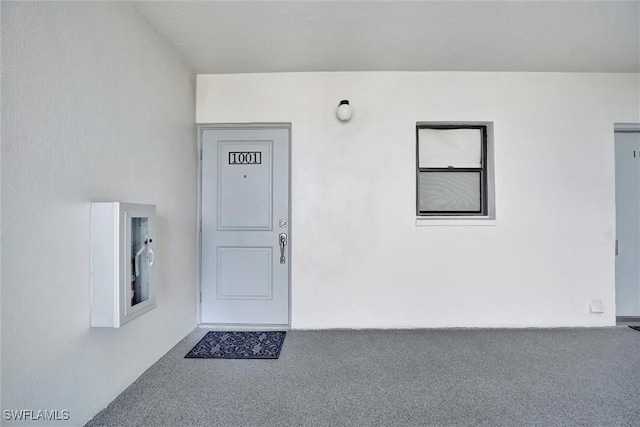 entrance to property featuring stucco siding