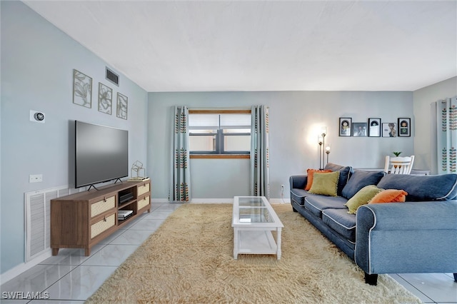 tiled living area featuring baseboards and visible vents