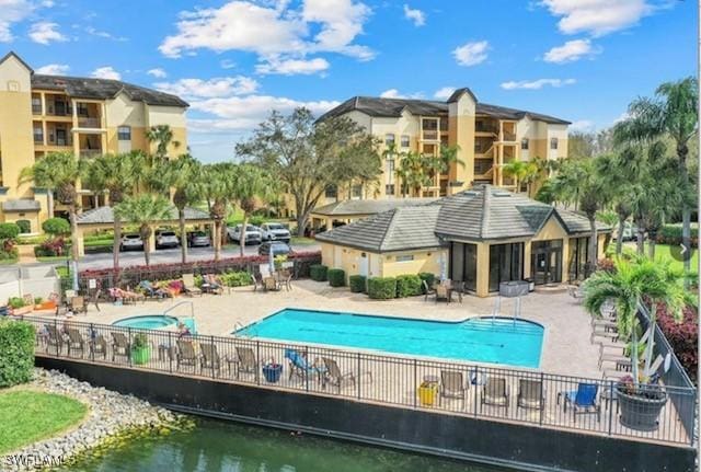 view of pool with a patio and a community hot tub