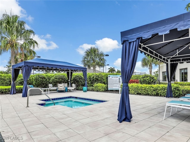 view of pool with a gazebo, a hot tub, and a patio