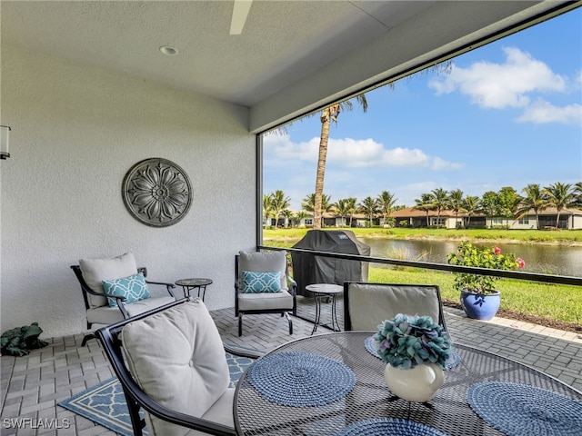 sunroom / solarium with a water view