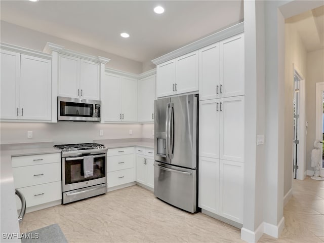 kitchen with white cabinetry and appliances with stainless steel finishes