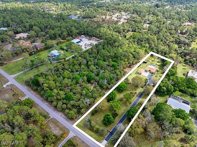 birds eye view of property with a forest view