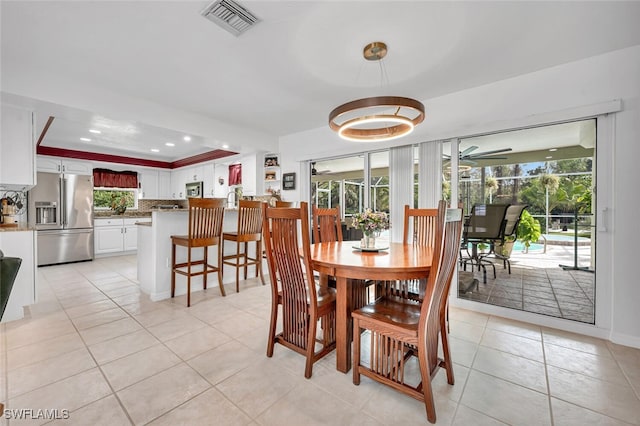 dining space with a wealth of natural light, visible vents, light tile patterned flooring, and recessed lighting