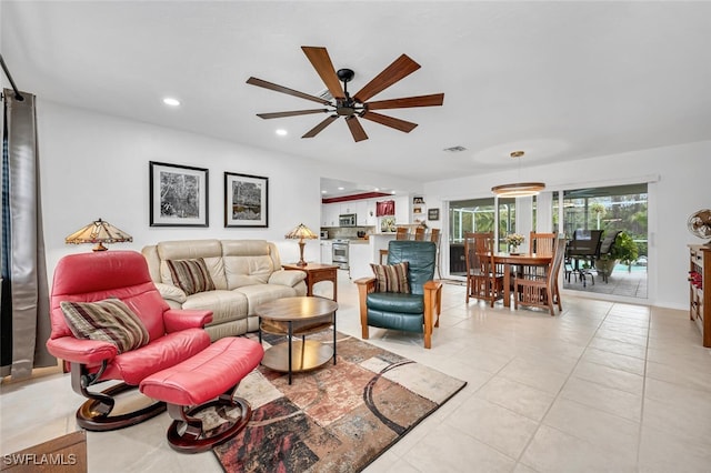 living room with light tile patterned floors, visible vents, a ceiling fan, and recessed lighting