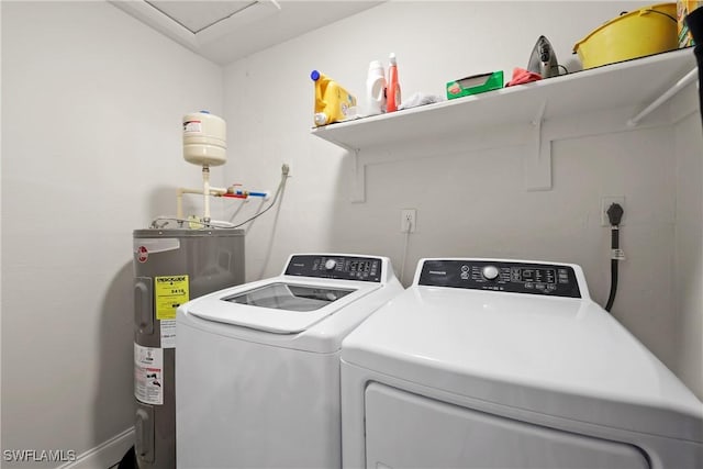 washroom with water heater and washing machine and clothes dryer