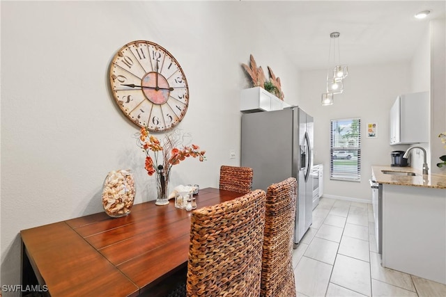 dining space with sink and light tile patterned flooring