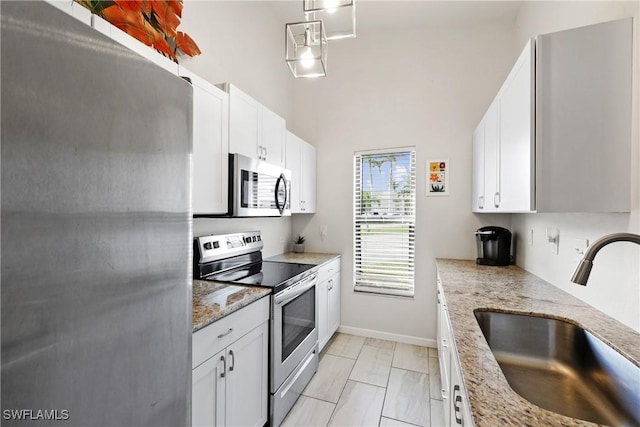 kitchen with white cabinetry, sink, and stainless steel appliances