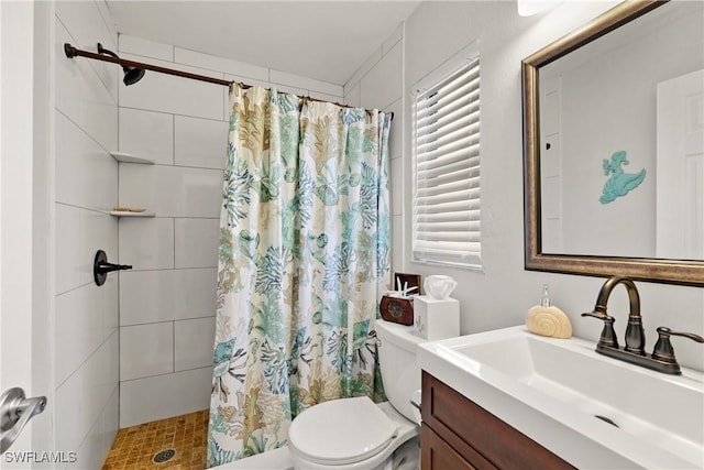 bathroom featuring vanity, toilet, and curtained shower