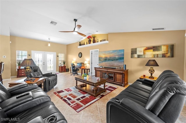 tiled living room featuring lofted ceiling, french doors, and ceiling fan