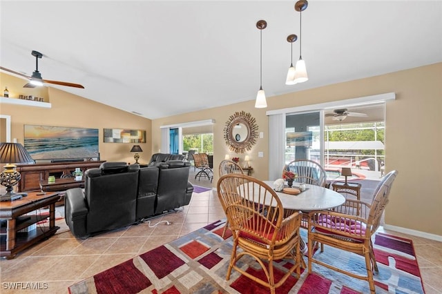 dining area with lofted ceiling, light tile patterned floors, and ceiling fan