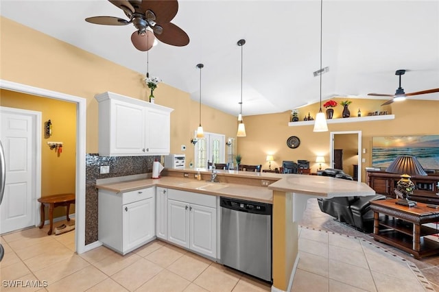 kitchen with pendant lighting, sink, light tile patterned floors, white cabinetry, and stainless steel dishwasher