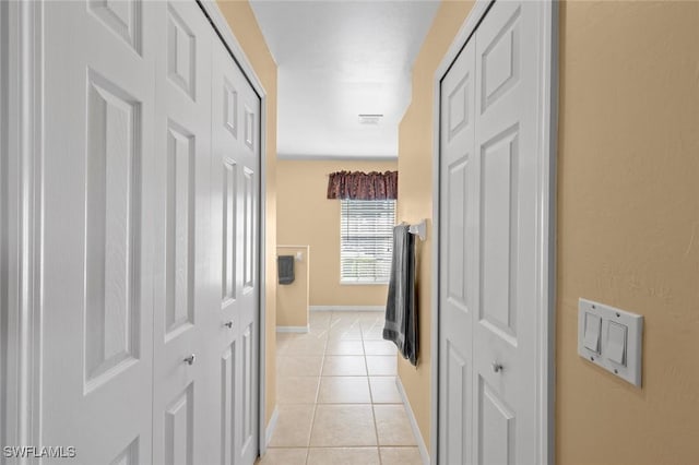 hall featuring light tile patterned floors