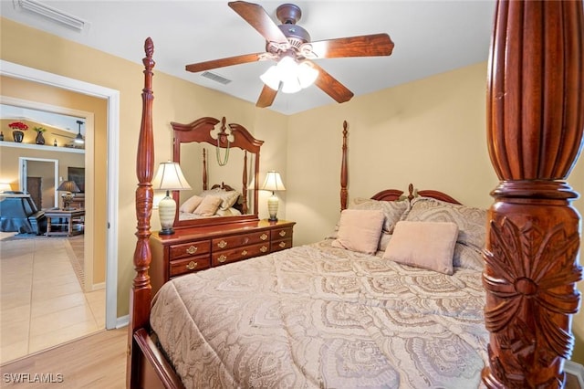 tiled bedroom featuring ceiling fan