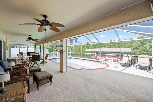 view of pool featuring a lanai, a patio, and ceiling fan