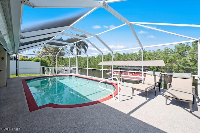 view of swimming pool with a patio, a water view, and glass enclosure