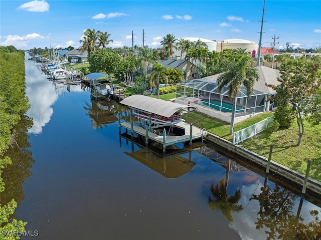 view of dock with a lanai and a water view