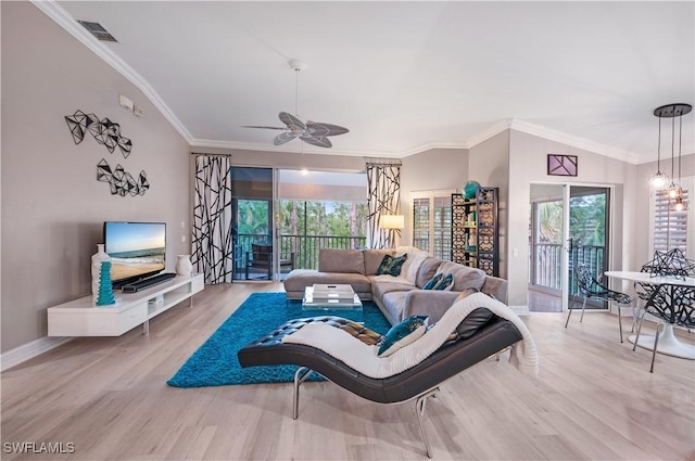 living room with visible vents, crown molding, baseboards, ceiling fan, and wood finished floors