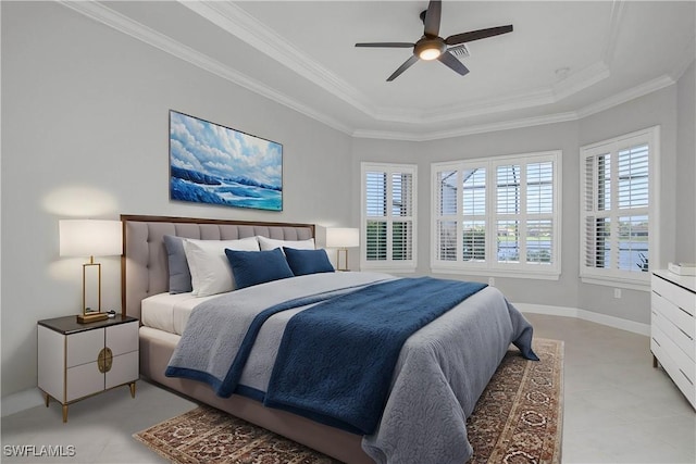 bedroom with a tray ceiling, crown molding, and ceiling fan