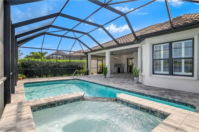 view of swimming pool featuring a lanai, a patio area, ceiling fan, and an in ground hot tub