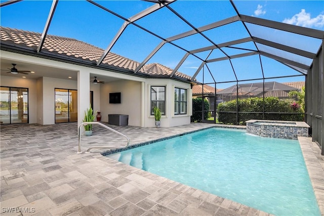 view of pool featuring an in ground hot tub, ceiling fan, a lanai, and a patio area