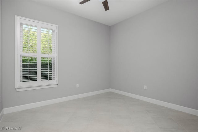 tiled empty room with ceiling fan