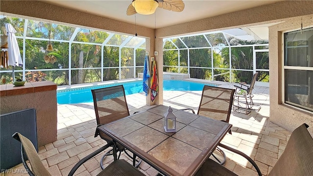 view of swimming pool with a lanai, ceiling fan, and a patio area