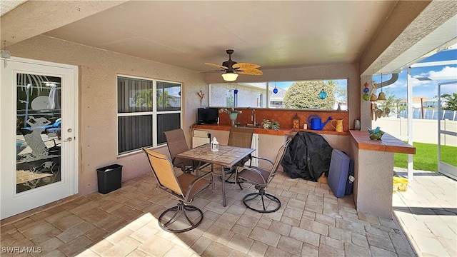 view of patio / terrace with a wet bar and ceiling fan