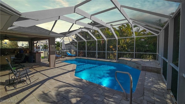 view of pool featuring a patio area and glass enclosure