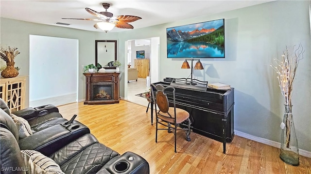 living room featuring ceiling fan and wood-type flooring