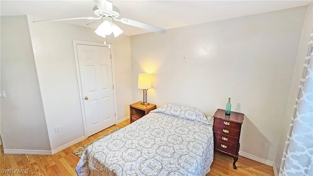 bedroom with light hardwood / wood-style floors and ceiling fan