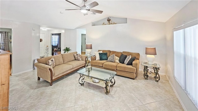 living room with ceiling fan, vaulted ceiling, and light tile patterned floors