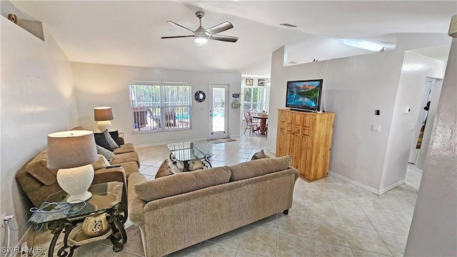 living room with ceiling fan, vaulted ceiling, and light tile patterned floors