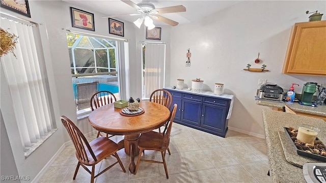 dining area with light tile patterned flooring and ceiling fan