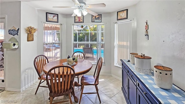 dining area with ceiling fan and light tile patterned floors