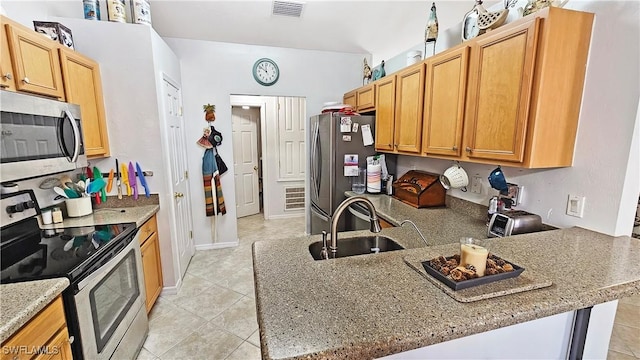 kitchen featuring sink, stainless steel appliances, light stone counters, light tile patterned flooring, and kitchen peninsula