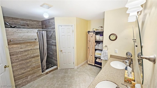 bathroom featuring walk in shower, vanity, and tile patterned flooring