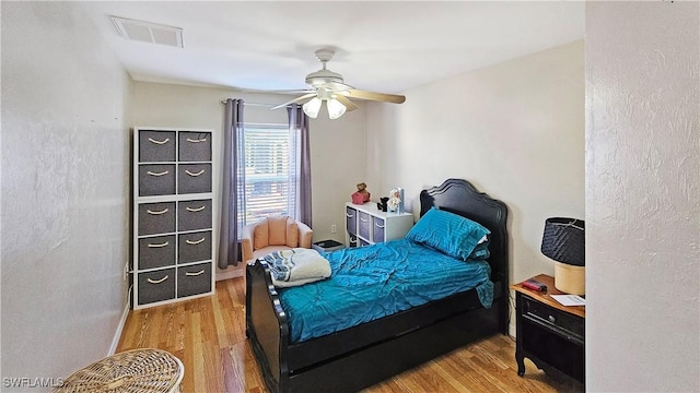 bedroom with ceiling fan and hardwood / wood-style floors