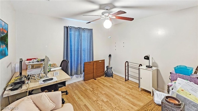 office space featuring ceiling fan and light hardwood / wood-style floors