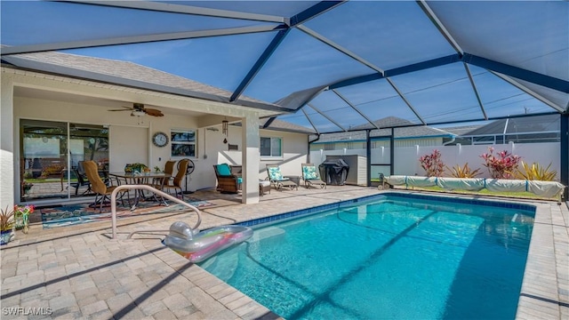 view of pool featuring a patio area, a lanai, a ceiling fan, and a fenced in pool