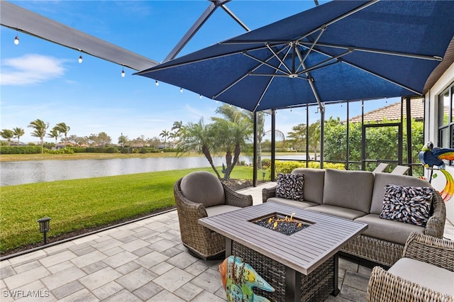 view of patio / terrace featuring a water view and an outdoor living space with a fire pit