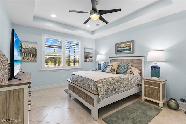 bedroom with light tile patterned floors, recessed lighting, a raised ceiling, ceiling fan, and baseboards