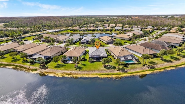 bird's eye view featuring a water view and a residential view