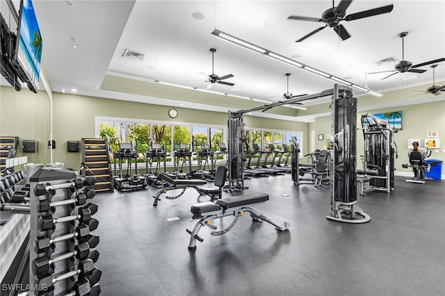 gym featuring visible vents and a raised ceiling