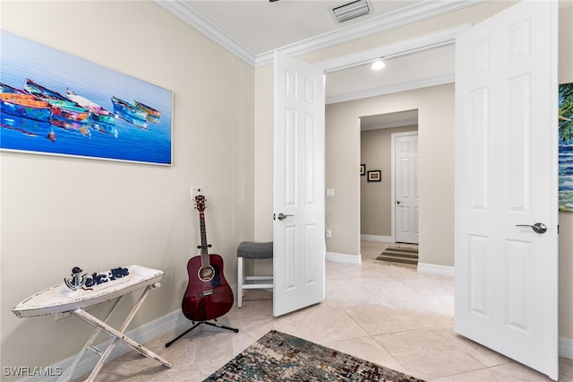 interior space with visible vents, crown molding, baseboards, and light tile patterned floors