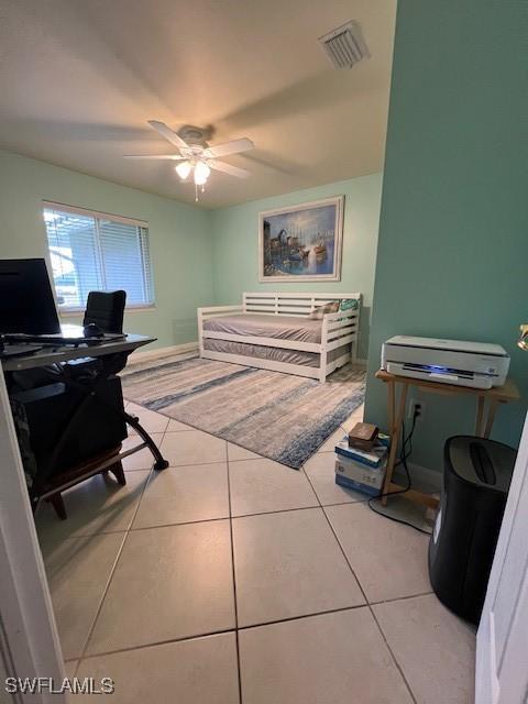 tiled office space featuring ceiling fan