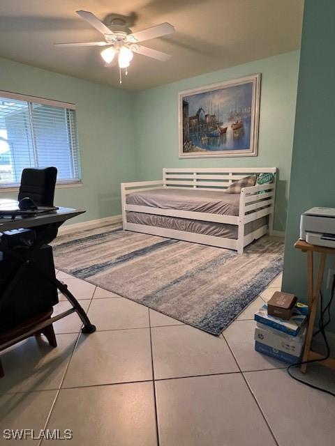 tiled bedroom featuring ceiling fan