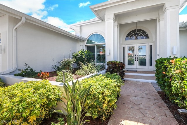 entrance to property with stucco siding and french doors