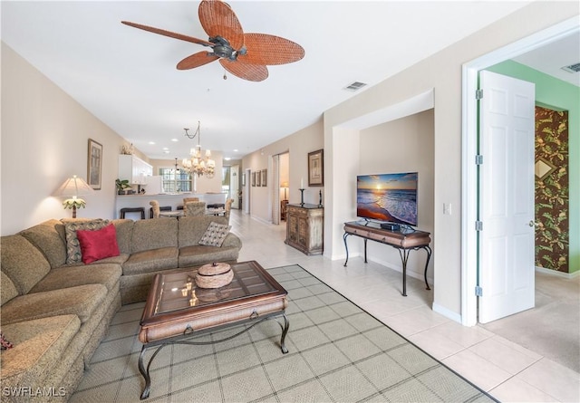 living room with ceiling fan with notable chandelier, light tile patterned floors, visible vents, and baseboards